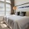 a bedroom with a bed and lamps