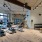 a room with a wood floor and a wood floor with a desk and chairs and a wood floor